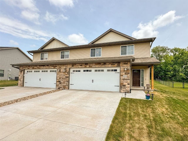 1004 Creekside Dr, Tiffin, IA 52340 - view of front facade with concrete driveway, stone siding, and a garage