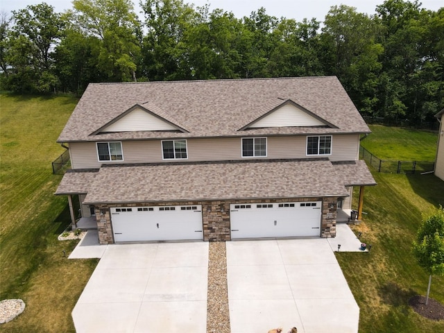 1004 Creekside Dr, Tiffin, IA 52340 - view of front of home with driveway, roof with shingles, stone siding, and an attached garage