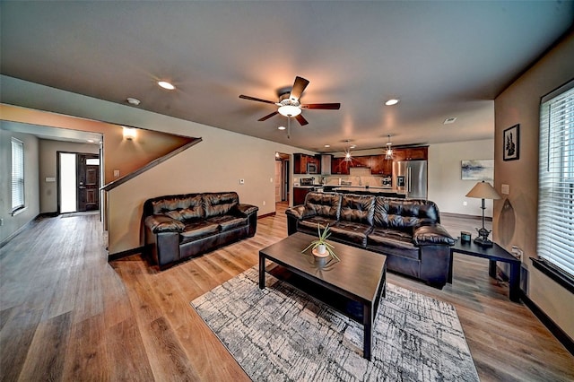 1004 Creekside Dr, Tiffin, IA 52340 - living room featuring light wood finished floors, a ceiling fan, and recessed lighting
