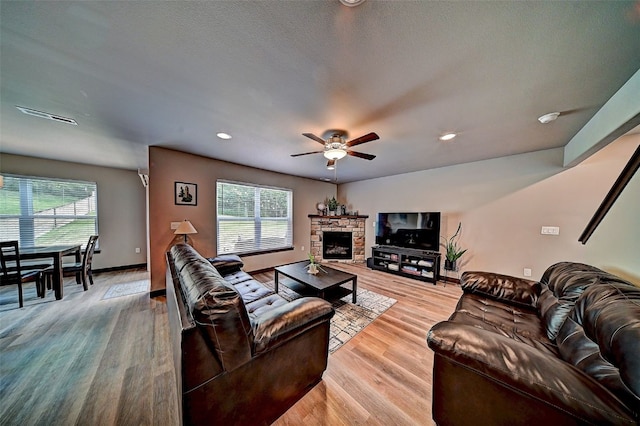 1004 Creekside Dr, Tiffin, IA 52340 - living area with a ceiling fan, plenty of natural light, light wood finished floors, recessed lighting, and a fireplace