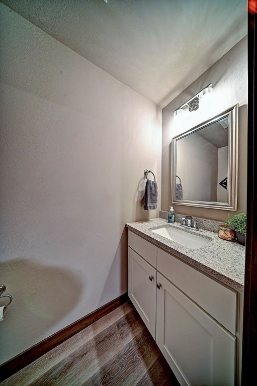 1004 Creekside Dr, Tiffin, IA 52340 - bathroom with wood finished floors and vanity