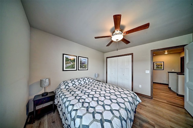 1004 Creekside Dr, Tiffin, IA 52340 - bedroom featuring wood finished floors, a closet, and ceiling fan