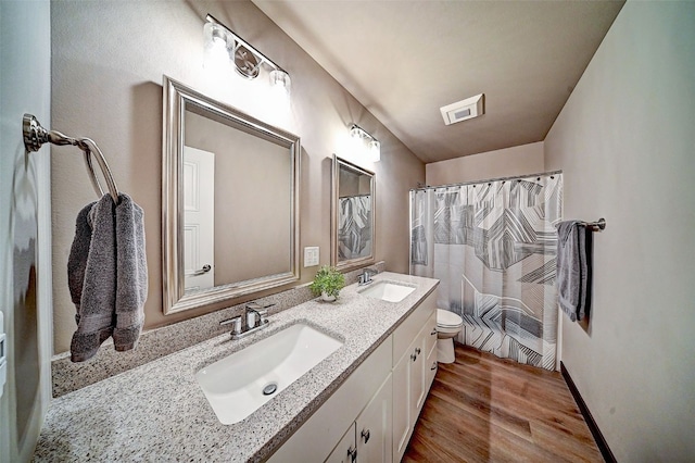 1004 Creekside Dr, Tiffin, IA 52340 - bathroom featuring double vanity, wood finished floors, and curtained shower