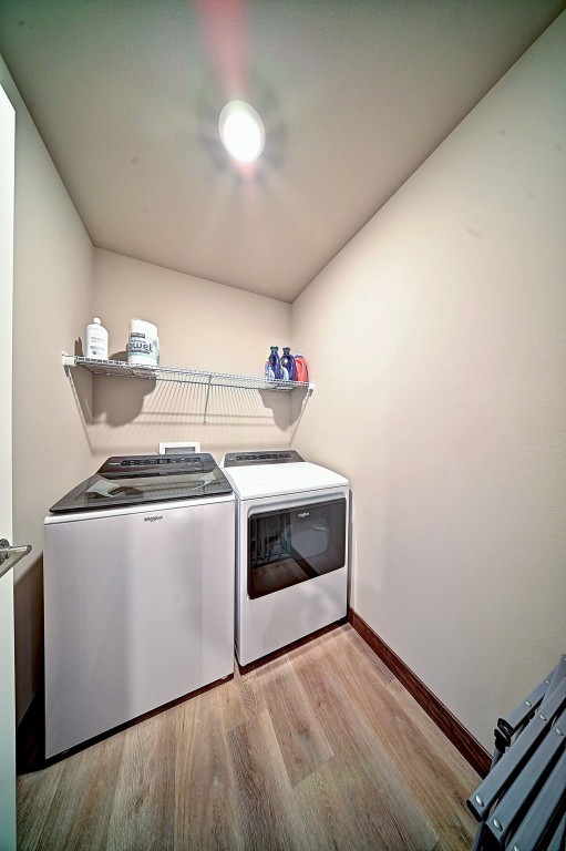 1004 Creekside Dr, Tiffin, IA 52340 - laundry area featuring independent washer and dryer and wood finished floors