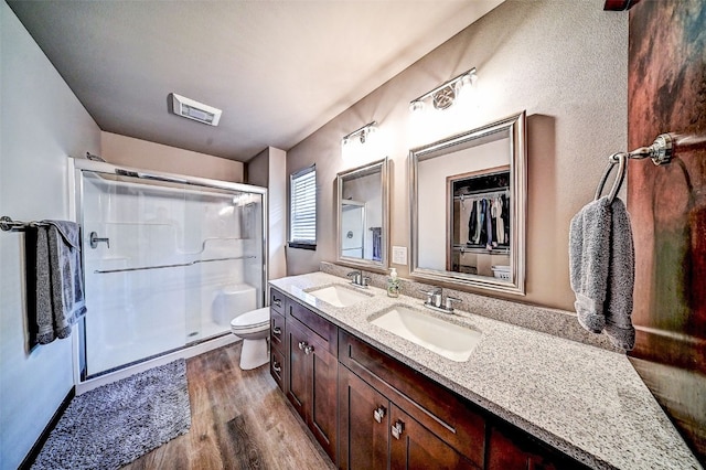 1004 Creekside Dr, Tiffin, IA 52340 - bathroom featuring wood finished floors, a shower stall, and double vanity