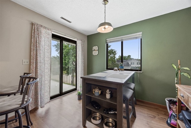 4485 Armar Dr SE Unit 101, Cedar Rapids, IA 52403 - dining space featuring a textured ceiling and wood finished floors