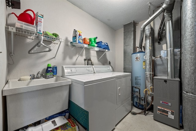 4485 Armar Dr SE Unit 101, Cedar Rapids, IA 52403 - laundry room with gas water heater, washer and dryer, a textured ceiling, and heating unit