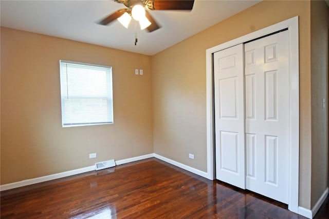 1545 26th St, Marion, IA 52302 - unfurnished bedroom with dark wood-type flooring, a closet, and ceiling fan