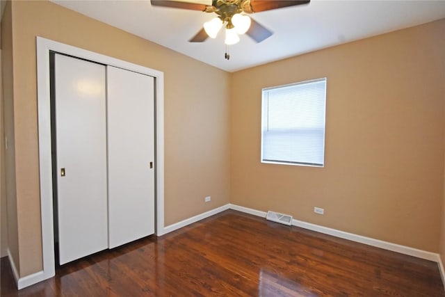 1545 26th St, Marion, IA 52302 - unfurnished bedroom with wood finished floors, a closet, and a ceiling fan