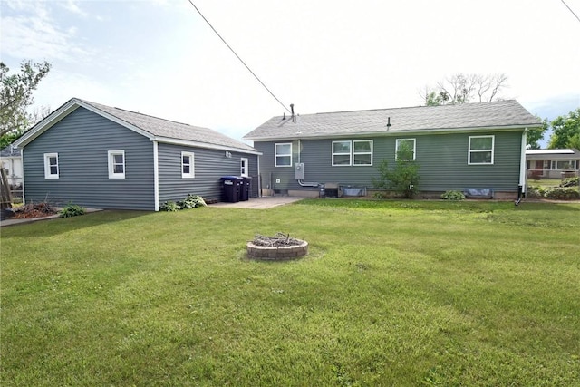 1545 26th St, Marion, IA 52302 - rear view of house with a fire pit, a lawn, and a patio