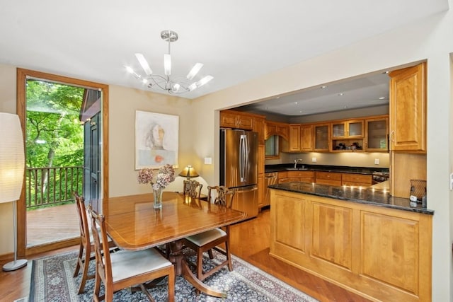 2520 NE Sugar Bottom Rd, Solon, IA 52333 - dining area with light wood finished floors and a chandelier