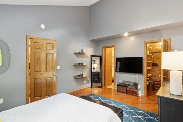 2520 NE Sugar Bottom Rd, Solon, IA 52333 - bedroom featuring wood finished floors, a high ceiling, and connected bathroom