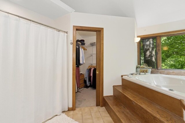 2520 NE Sugar Bottom Rd, Solon, IA 52333 - full bath featuring tile patterned floors, a bath, a walk in closet, and a shower with shower curtain