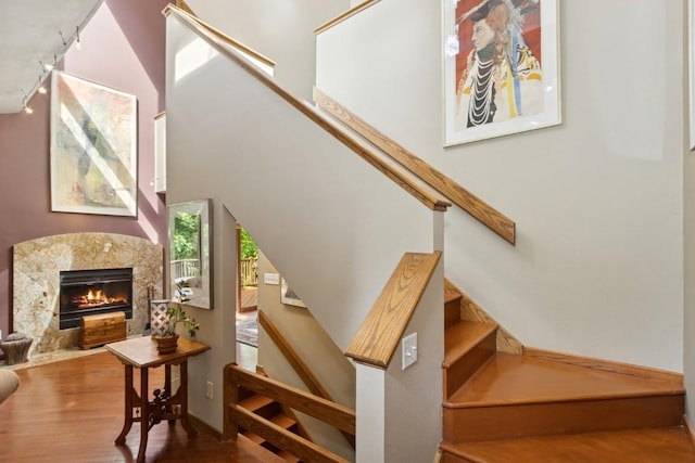2520 NE Sugar Bottom Rd, Solon, IA 52333 - stairs with track lighting, wood finished floors, and a high end fireplace