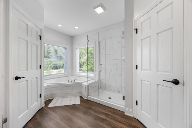 1574 Turkey Ridge Ct NW, Swisher, IA 52338 - bathroom featuring a garden tub, a shower stall, wood finished floors, and recessed lighting