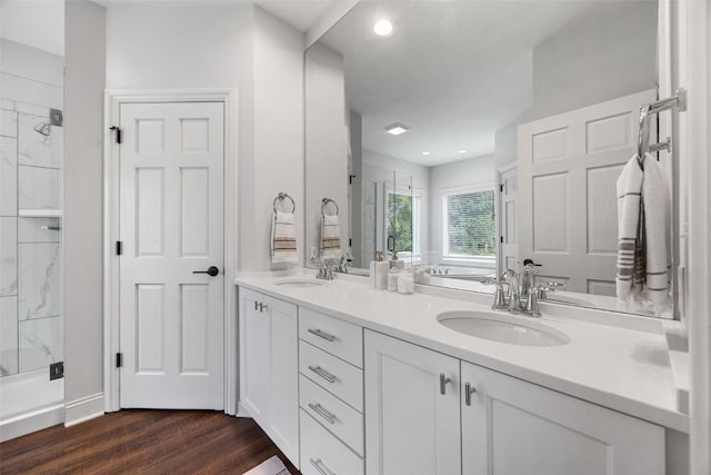 1574 Turkey Ridge Ct NW, Swisher, IA 52338 - bathroom with double vanity, a shower stall, wood finished floors, a tub to relax in, and recessed lighting