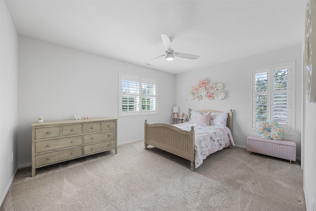1574 Turkey Ridge Ct NW, Swisher, IA 52338 - bedroom featuring multiple windows, light carpet, and a ceiling fan