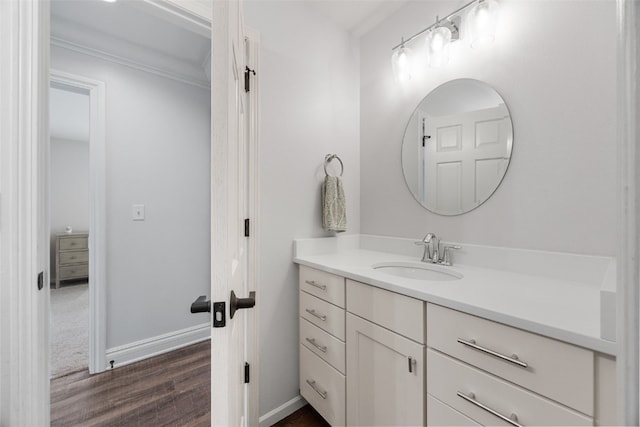 1574 Turkey Ridge Ct NW, Swisher, IA 52338 - bathroom with vanity, wood finished floors, and ornamental molding