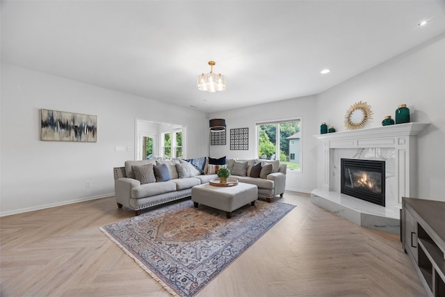 1574 Turkey Ridge Ct NW, Swisher, IA 52338 - living room with a fireplace, a chandelier, and recessed lighting