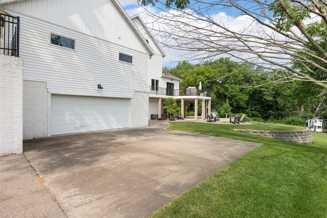 1574 Turkey Ridge Ct NW, Swisher, IA 52338 - view of side of home featuring brick siding, a yard, an attached garage, and a balcony