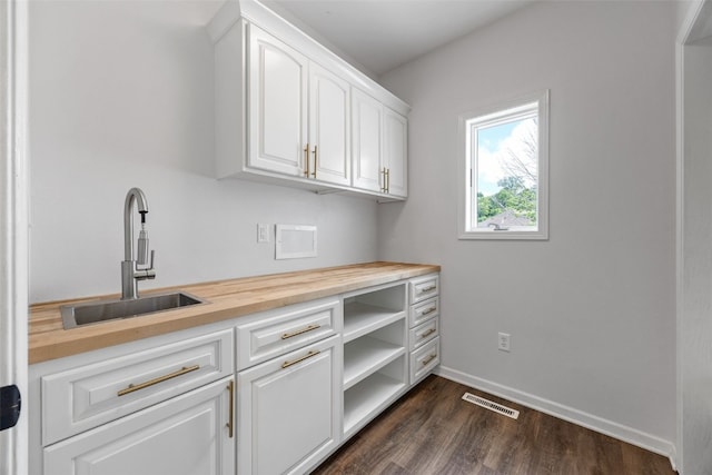 1574 Turkey Ridge Ct NW, Swisher, IA 52338 - bar with a sink and dark wood-style floors