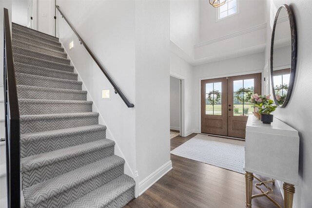 1574 Turkey Ridge Ct NW, Swisher, IA 52338 - entrance foyer with a towering ceiling, dark wood finished floors, stairs, and french doors