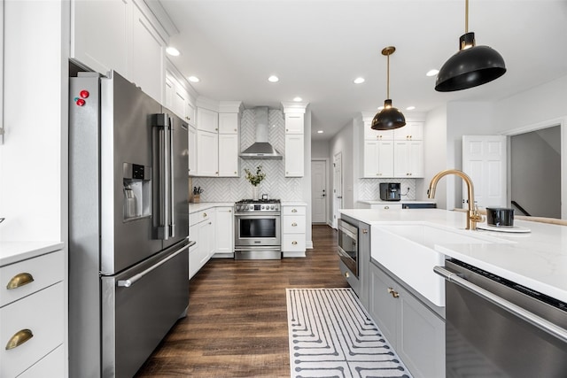 1574 Turkey Ridge Ct NW, Swisher, IA 52338 - kitchen featuring high end appliances, wall chimney exhaust hood, dark wood-style floors, white cabinets, and recessed lighting