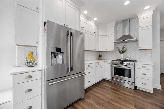 1574 Turkey Ridge Ct NW, Swisher, IA 52338 - kitchen featuring appliances with stainless steel finishes, wall chimney range hood, light countertops, tasteful backsplash, and recessed lighting