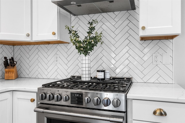 1574 Turkey Ridge Ct NW, Swisher, IA 52338 - kitchen with stainless steel gas range oven, range hood, decorative backsplash, and white cabinets