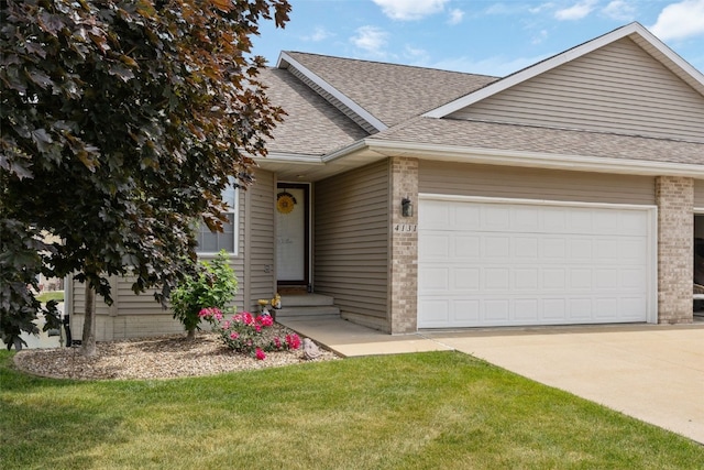 4131 Lakeview Dr SW, Cedar Rapids, IA 52404 - view of front of home with roof with shingles, brick siding, a garage, driveway, and a front yard
