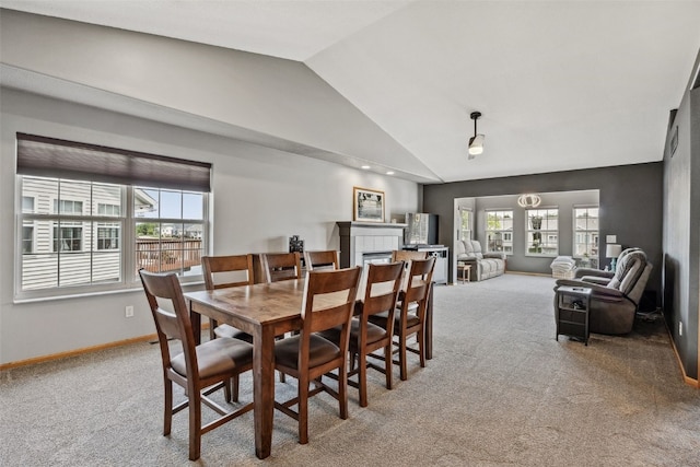 4131 Lakeview Dr SW, Cedar Rapids, IA 52404 - dining area with lofted ceiling, carpet flooring, healthy amount of natural light, and a tile fireplace