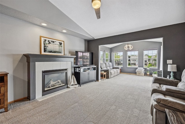 4131 Lakeview Dr SW, Cedar Rapids, IA 52404 - living room with carpet, vaulted ceiling, a fireplace, a ceiling fan, and recessed lighting