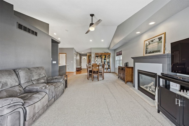 4131 Lakeview Dr SW, Cedar Rapids, IA 52404 - living room with a ceiling fan, recessed lighting, lofted ceiling, light colored carpet, and a fireplace