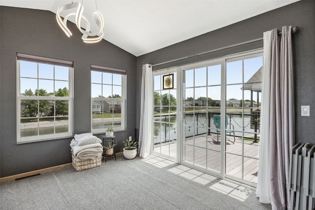 4131 Lakeview Dr SW, Cedar Rapids, IA 52404 - entryway with lofted ceiling, a chandelier, carpet floors, and a water view
