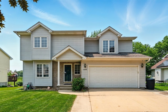 1255 Pacific St, Ely, IA 52227 - view of front of home with concrete driveway, a front lawn, and an attached garage