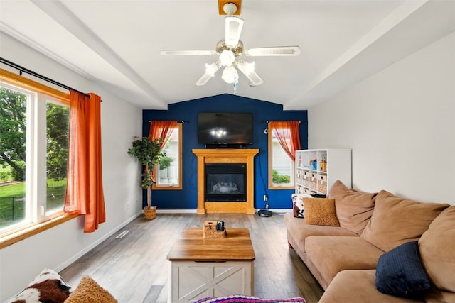 1255 Pacific St, Ely, IA 52227 - living area with lofted ceiling, wood finished floors, a ceiling fan, and a glass covered fireplace