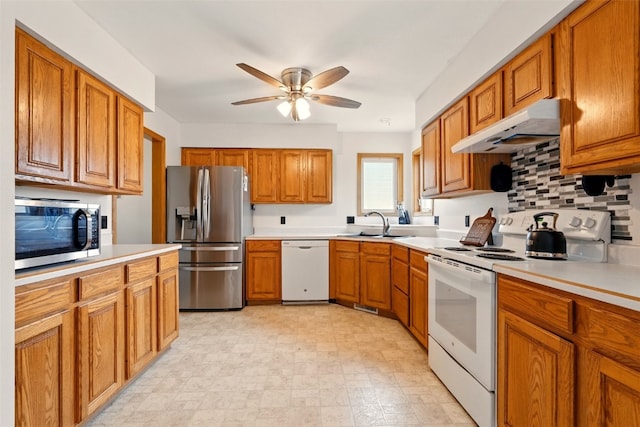 1255 Pacific St, Ely, IA 52227 - kitchen with stainless steel appliances, under cabinet range hood, brown cabinetry, and ceiling fan