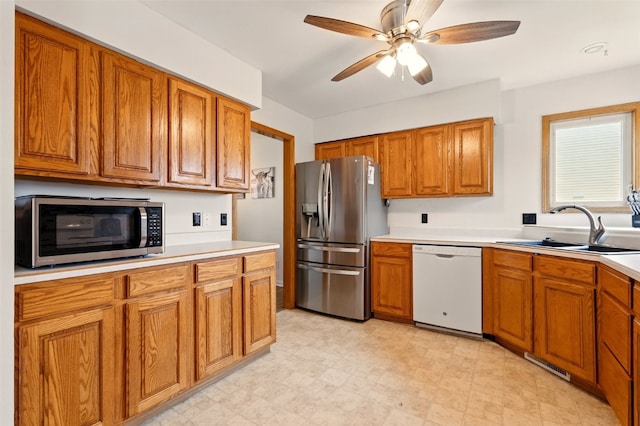 1255 Pacific St, Ely, IA 52227 - kitchen with appliances with stainless steel finishes, brown cabinets, ceiling fan, and light countertops