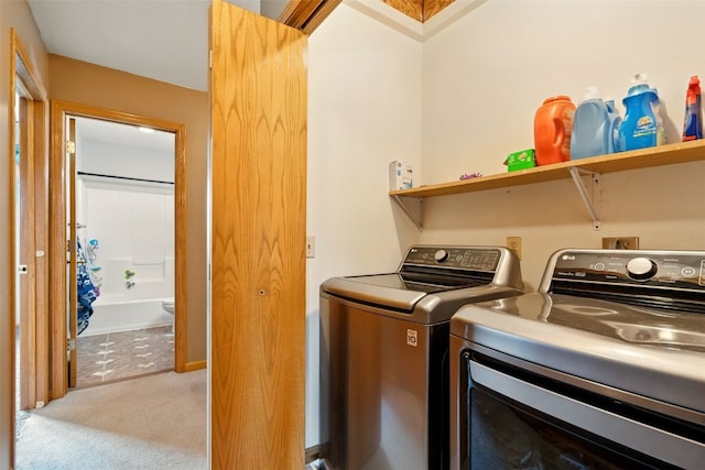 1255 Pacific St, Ely, IA 52227 - laundry area featuring washing machine and clothes dryer and carpet