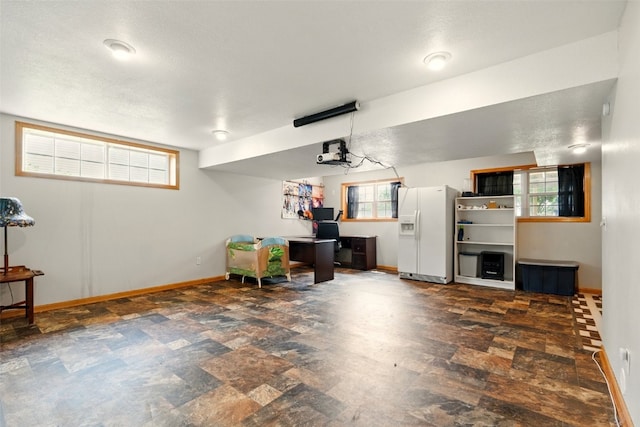 1255 Pacific St, Ely, IA 52227 - garage with white refrigerator with ice dispenser and an office area