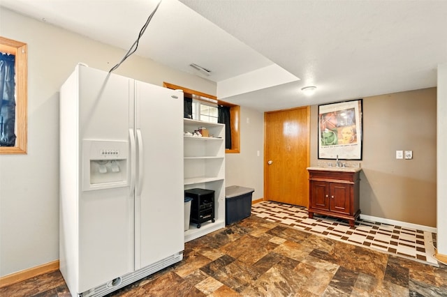 1255 Pacific St, Ely, IA 52227 - kitchen with white fridge with ice dispenser and light countertops