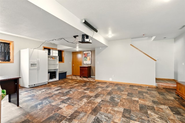 1255 Pacific St, Ely, IA 52227 - unfurnished living room with baseboards and stone finish flooring