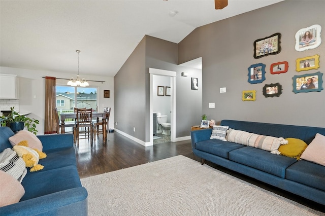 310 Agape Ave, Urbana, IA 52345 - living area featuring a chandelier, dark wood finished floors, and vaulted ceiling
