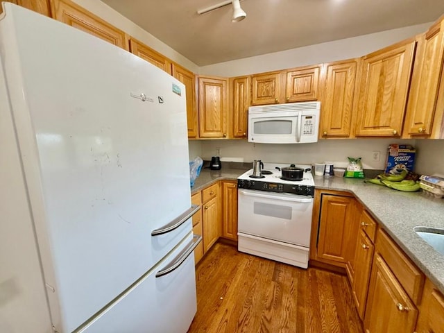 2208 Holiday Rd, Coralville, IA 52241 - kitchen with white appliances, wood finished floors, and light countertops