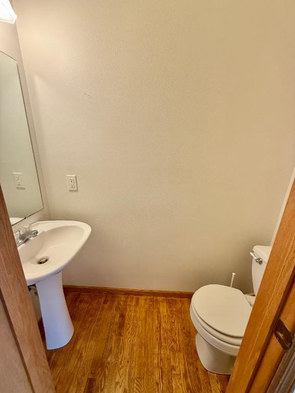 2208 Holiday Rd, Coralville, IA 52241 - half bathroom with wood finished floors and toilet
