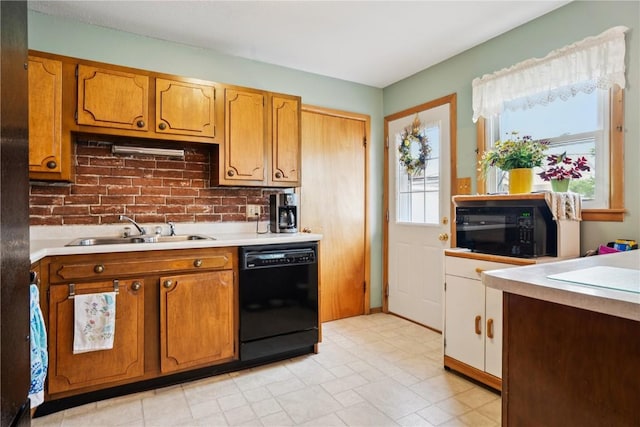 433 Cherry Hill Rd NW, Cedar Rapids, IA 52405 - kitchen with black appliances, light countertops, brown cabinets, and tasteful backsplash