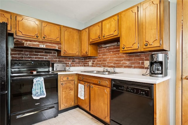 433 Cherry Hill Rd NW, Cedar Rapids, IA 52405 - kitchen featuring black appliances, under cabinet range hood, light countertops, and brown cabinets