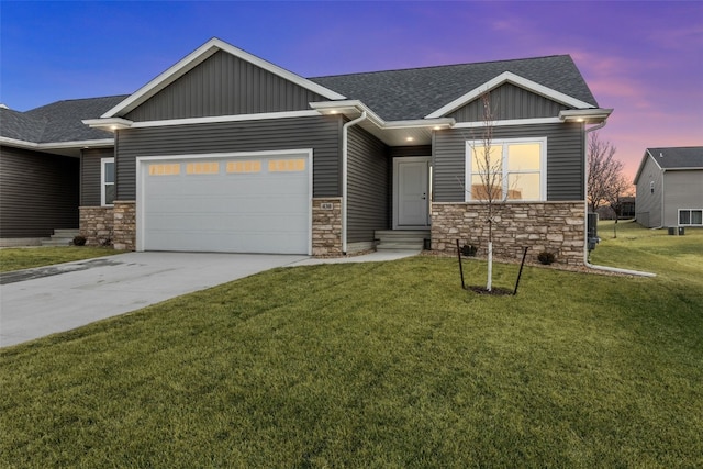 430 15th Ave SW, Mount Vernon, IA 52314 - view of front of home featuring stone siding, a garage, and a yard