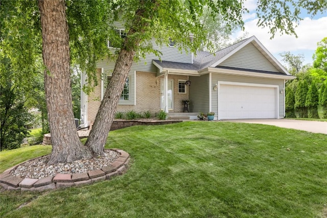 4127 Harwood Dr NE, Cedar Rapids, IA 52411 - view of front of property with concrete driveway, an attached garage, a front yard, and brick siding