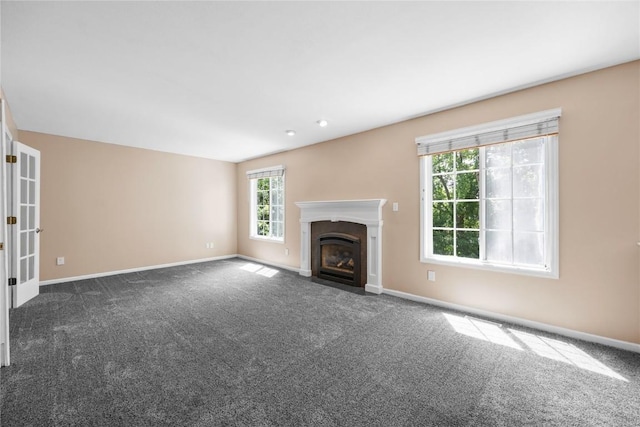 4127 Harwood Dr NE, Cedar Rapids, IA 52411 - unfurnished living room featuring dark carpet and a fireplace with flush hearth
